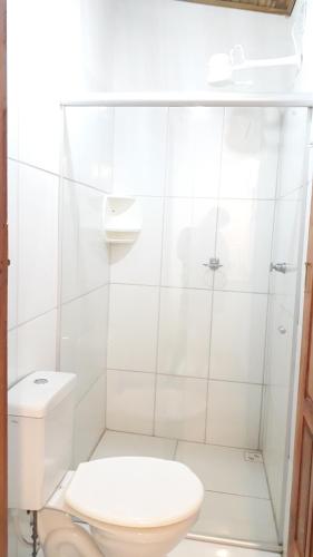 a white bathroom with a toilet and a sink at Pousada João Maria in Trancoso