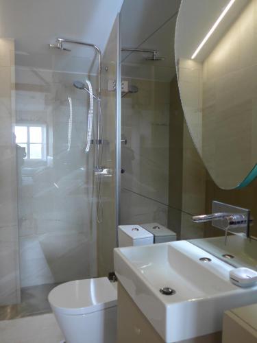 a bathroom with a sink and a shower and a toilet at The Porto Way in Porto