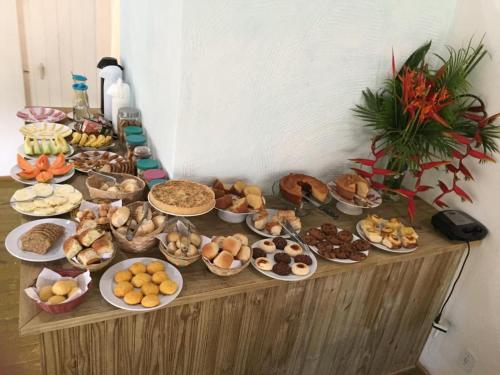 a table filled with different types of food on it at Pousada João Maria in Trancoso