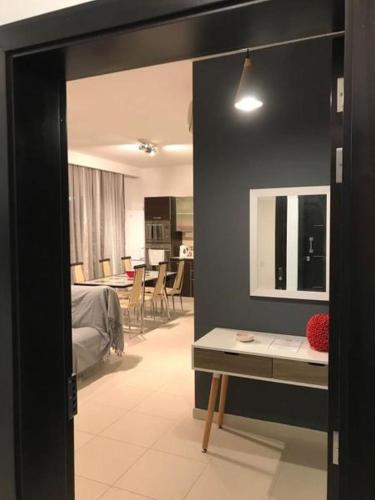 a room with a bedroom with a mirror and a table at Ocean View, Apartment 1 in Marsaskala