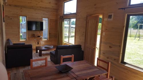 a living room with a couch and a table at Rustico Pucon in Pucón