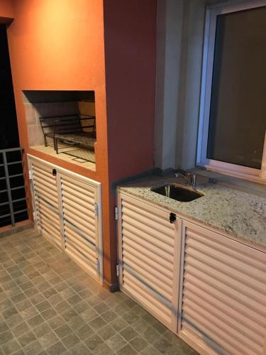 a kitchen with a sink and a counter top at Departamento Leben in Colón