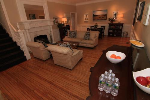 a living room with a couch and a table with drinks at Anchor Inn Beach House in Provincetown