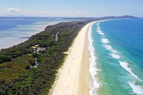 an aerial view of a beach and the ocean at Tiona Holiday Park in Tiona