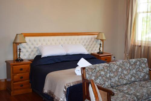 a bedroom with a bed and a couch at Left Bank in Kaikohe