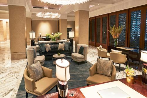 a living room filled with furniture and a large window at The Capitol Kempinski Hotel Singapore in Singapore