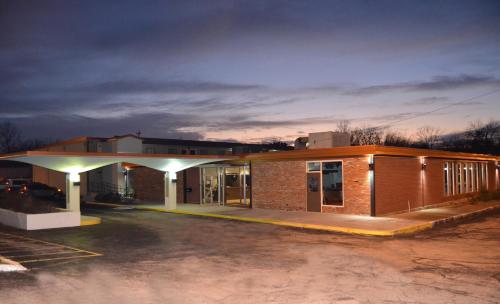 an empty parking lot in front of a building at Cascades Inn in Bloomington