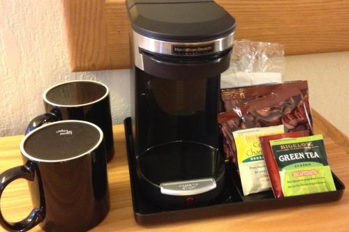 a coffee maker sitting on a counter next to a mug at Cascades Inn in Bloomington
