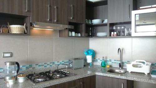 a kitchen with a sink and a counter top at Condominio Arena Maris in Algarrobo