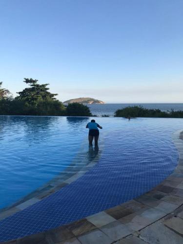 a person standing in the middle of a pool of water at TOTAL Mar in Niterói