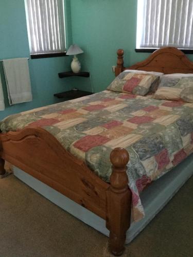 a bed with a quilt on it in a bedroom at Shark Bay Views B & B in Denham