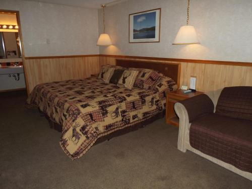 a hotel room with a bed and a couch at Caboose Motel in Libby