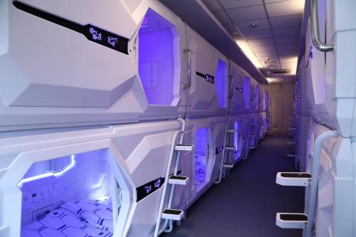 an empty train car with purple lights on at Dormitos in Manila