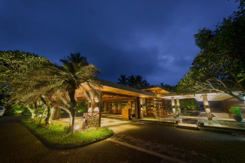 a building with palm trees in front of it at The Samaya Ubud in Ubud