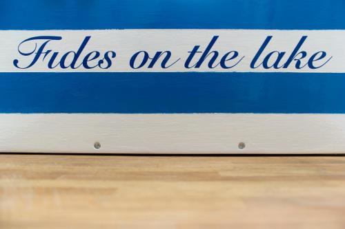 a blue and white sign that reads rides on the lake at FIDES ON THE LAKE in Marone