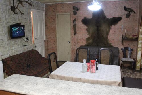 a dining room with a table and a tree on the wall at Little Star in Stepantsminda