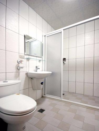 a bathroom with a toilet and a sink and a shower at Summer House in Hengchun South Gate