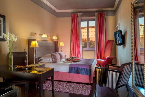 a hotel room with a bed and a window at The Inn at the Spanish Steps Luxury Collection - The Inn at the Spanish Steps in Rome