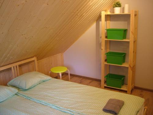 a bedroom with a bed and a book shelf at Mill Hause Apart 1 in Druskininkai
