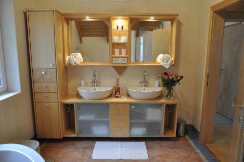 a bathroom with two sinks and a mirror at Ferienhaus Manuela in Velden am Wörthersee