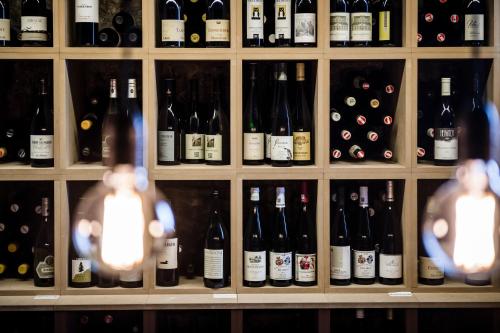 a bunch of bottles of wine on a shelf at Boutique & Gourmet Hotel Orso Grigio in San Candido