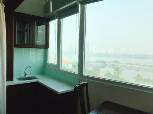 a kitchen with a sink and a large window at Khách sạn Công Đoàn Quảng Bá in Hanoi