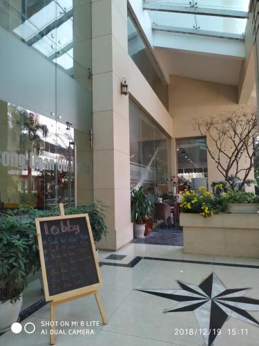 a sign in front of a building with a restaurant at Khách sạn Công Đoàn Quảng Bá in Hanoi