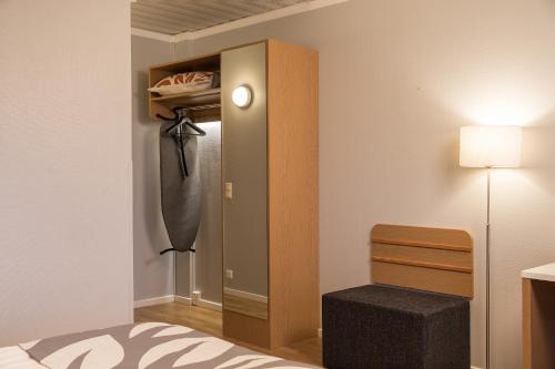 a bedroom with a closet with a bed and a lamp at Park Hotel Tornio in Tornio