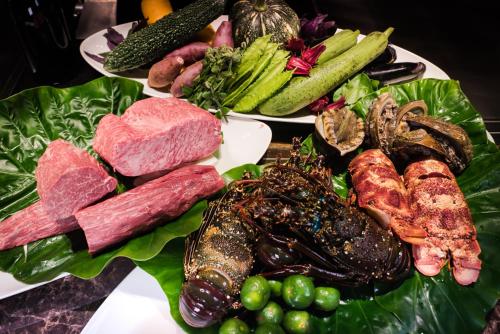 a plate of meat and vegetables on a table at The Shigira in Miyako Island