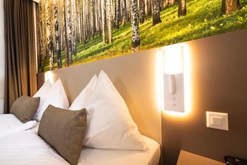 a bedroom with a bed with a painting on the wall at Hotel Waldhorn in Bern