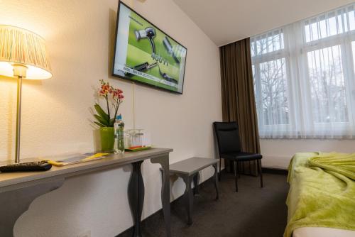 a room with a desk in a hotel room at Hotel Waldhorn in Bern