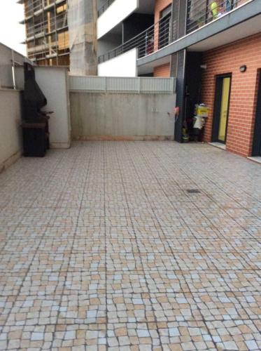 an empty brick parking lot with a building at ADALBERTO NASCIMENTO LUXURY APARTA-HOSTEL At COLINAS DO CRUZEIRO in Odivelas