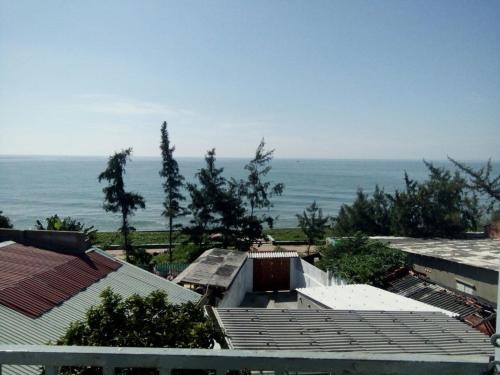 a view of the ocean from the roofs of houses at Minh Duc Guesthouse in Phan Thiet