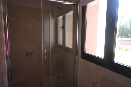 a shower with a glass door in a bathroom at Casa Nimajas in Vera