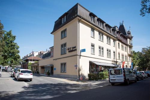 a large white building on the side of a street at Hotel Waldhorn in Bern