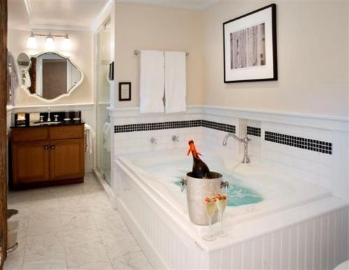 a bathroom with a tub with a statue in it at The Dorset Inn in Dorset