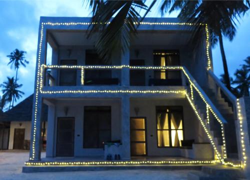 a house with lights on the front of it at White Dream in Kiwengwa