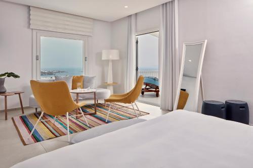 A bed or beds in a room at Myconian Kyma, a Member of Design Hotels