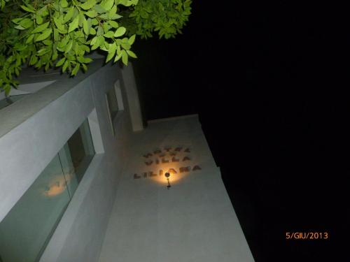 a building with a light on the side of it at night at Villa Liliana in Cervia