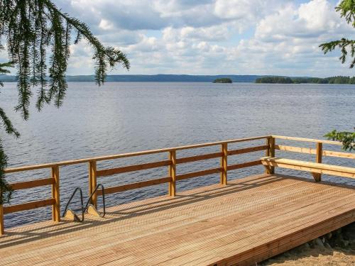 a wooden dock with a view of a lake at Holiday Home Huljakka by Interhome in Lipinlahti