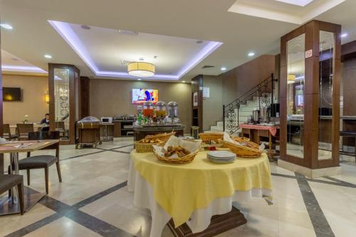 a restaurant with a table with baskets of food on it at TADJ EL MAOUADA in Sétif