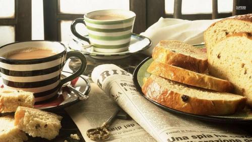 a table with a plate of bread and two cups of coffee at TADJ EL MAOUADA in Sétif