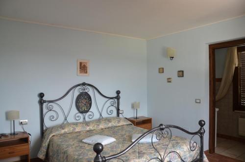 a bedroom with a bed with a black frame at B&B La Terrazza Del Subasio in Assisi