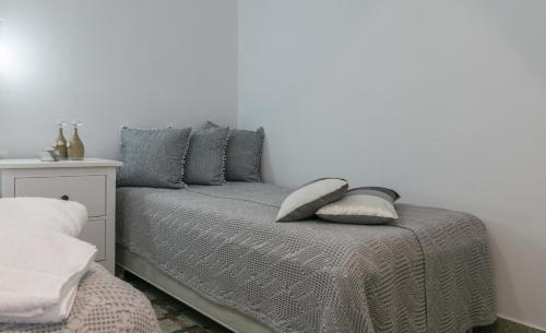 a bedroom with a bed with two pillows on it at Uncle's House luxury Suites in Adamas