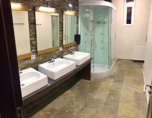 a bathroom with three sinks and a shower at SOKOLOVNA TRUTNOV in Trutnov