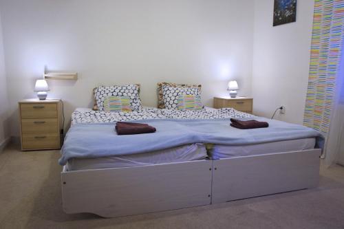 a bedroom with a large bed with two night stands at GRAN hostel in Banská Bystrica