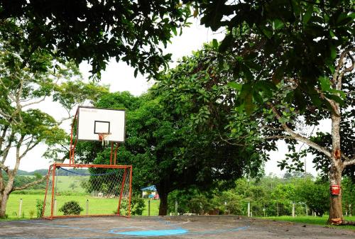 a basketball hoop in a park with a tree at Finca El Jecho in Villavicencio