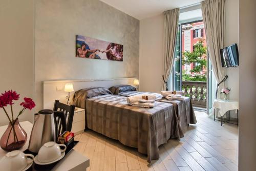 a bedroom with a bed and a large window at Rome Central Rooms in Rome