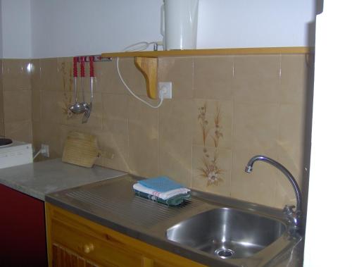 a kitchen sink with a faucet and a counter top at Aphrodite Studios & Pool in Paleokastritsa