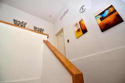 a staircase in a house with paintings on the wall at Hotel Boutique Trinidad in Viña del Mar
